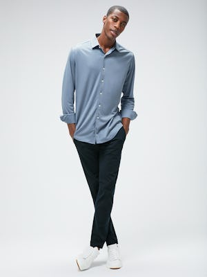 Men's Deep Sky Blue Oxford Apollo Brushed Shirt and Men's Navy Kinetic Pant on model with legs crossed