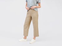 model wearing womens kinetic twill 5 pocket pant oatmeal heather and womens composite merino mock neck pale grey heather waist down front shot