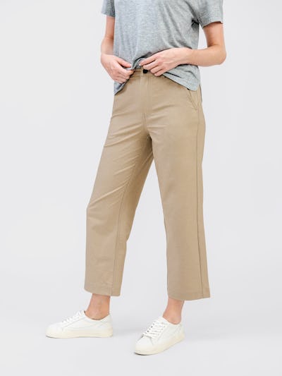 model wearing womens kinetic twill 5 pocket pant oatmeal heather and womens composite merino mock neck pale grey heather waist down front shot