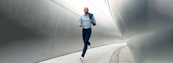 man running wearing velocity dress pant and apollo