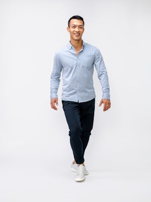 model wearing mens hybrid button down shirt light blue stripe full body walking front