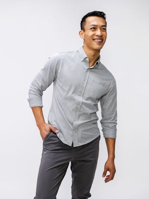 model wearing mens hybrid button down shirt light grey stripe knee up one hand in pocket