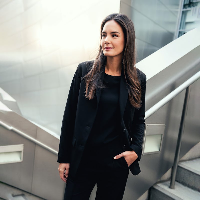 Woman wearing black Velocity Oversized Blazer with hand in pant pocket