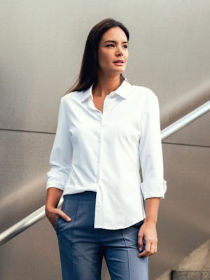 model wearing Women's Aero Zero Tailored Shirt White lifestyle one hand in pocket one side tucked in