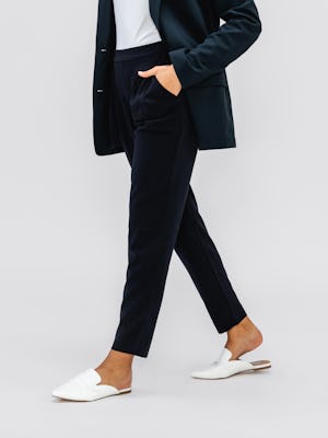 Navy Swift Drape Pant on model walking with hand in pocket
