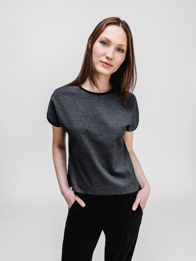 model wearing womens fusion double knit reversible tee black charcoal on model both hands in pocket