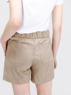 model wearing womens velocity tailored short flax flax pocket zoom in studio