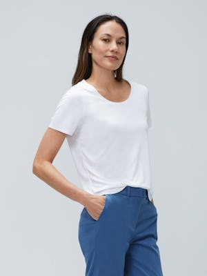 model wearing womens luxe touch tee white top half both hands in pocket