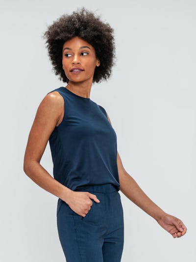 Women's Indigo Luxe Touch Tank and Indigo Heather Velocity Pant on model facing right