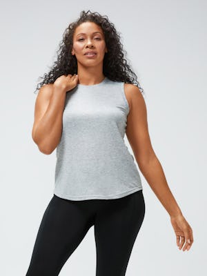 women's pale grey heather composite merino active tank and black joule active legging model facing forward hand on shoulder