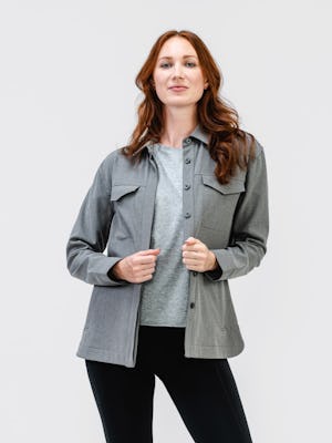 model wearing womens fusion overshirt medium grey heather womens joule active legging black full body both hands touching jacket