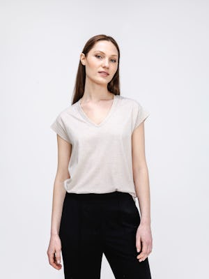 model wearing womens composite merino v neck tee taupe heather knee up both hands on side