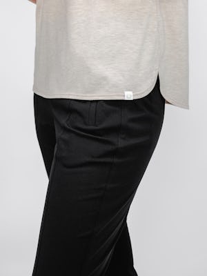 model wearing womens composite merino boxy tee taupe and womens kinetic pintuck pant black