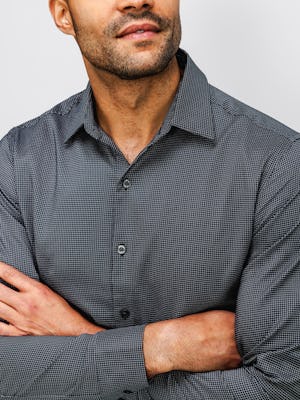Close up of Men's Aero Zero Dress Shirt Charcoal Mini Grid on model with crossed arms