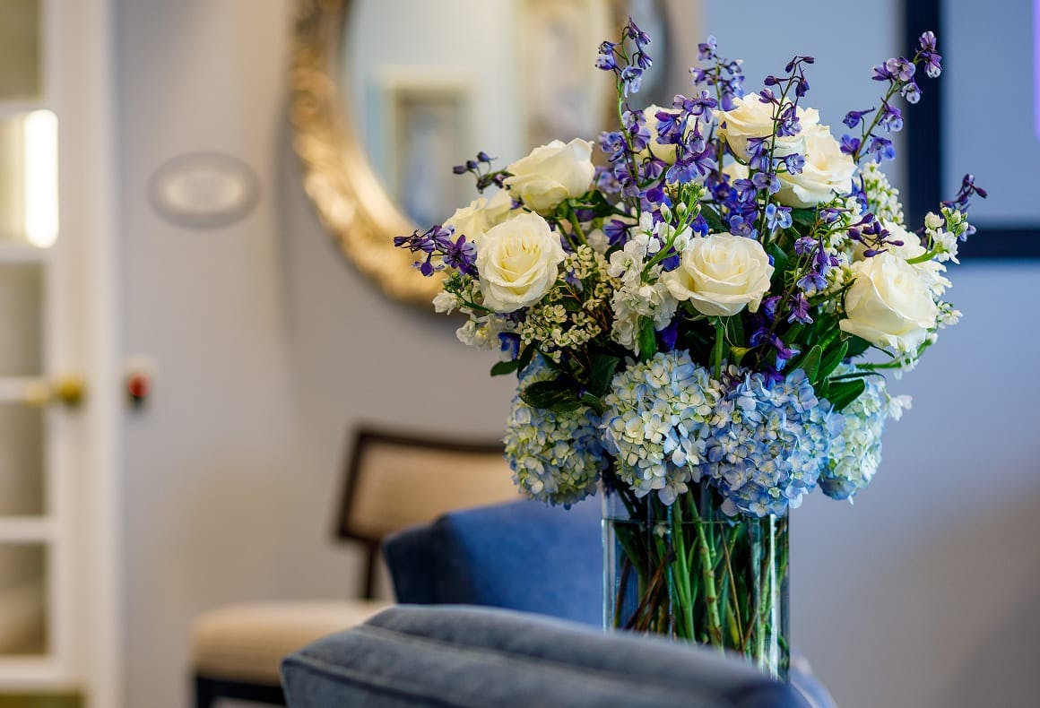 vase of purple, white and light blue flowers