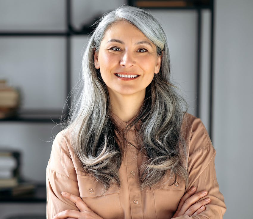 woman with gray hair looking forward and smiling