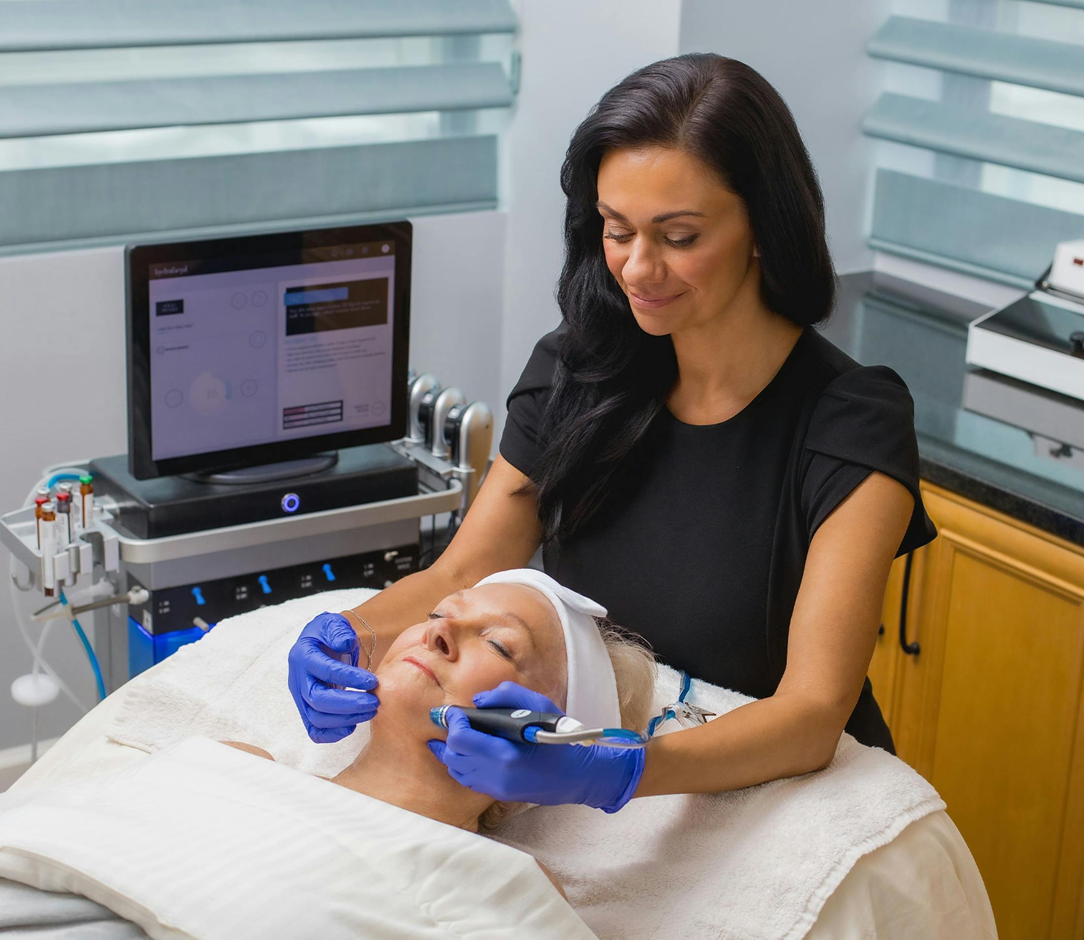 medical personnel using Microneedling tool on patients face