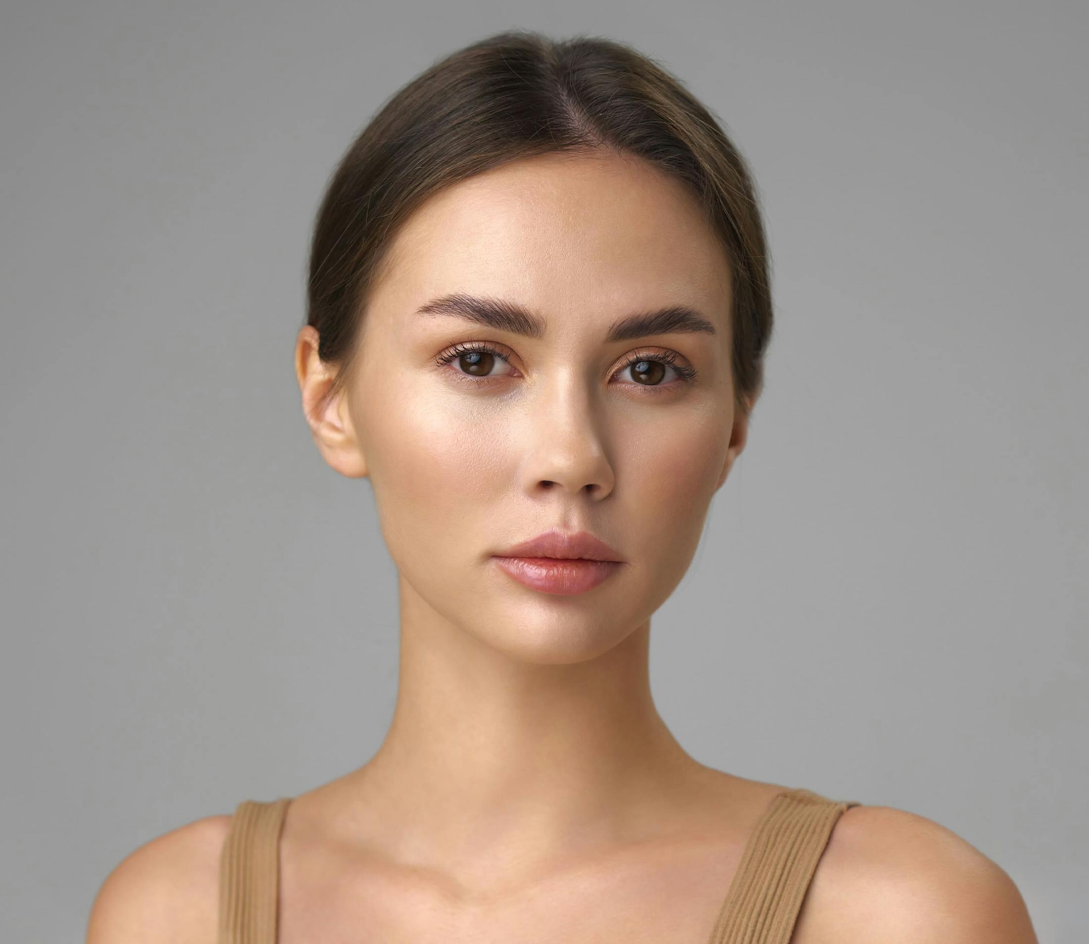 woman with hair in a bun looking forward
