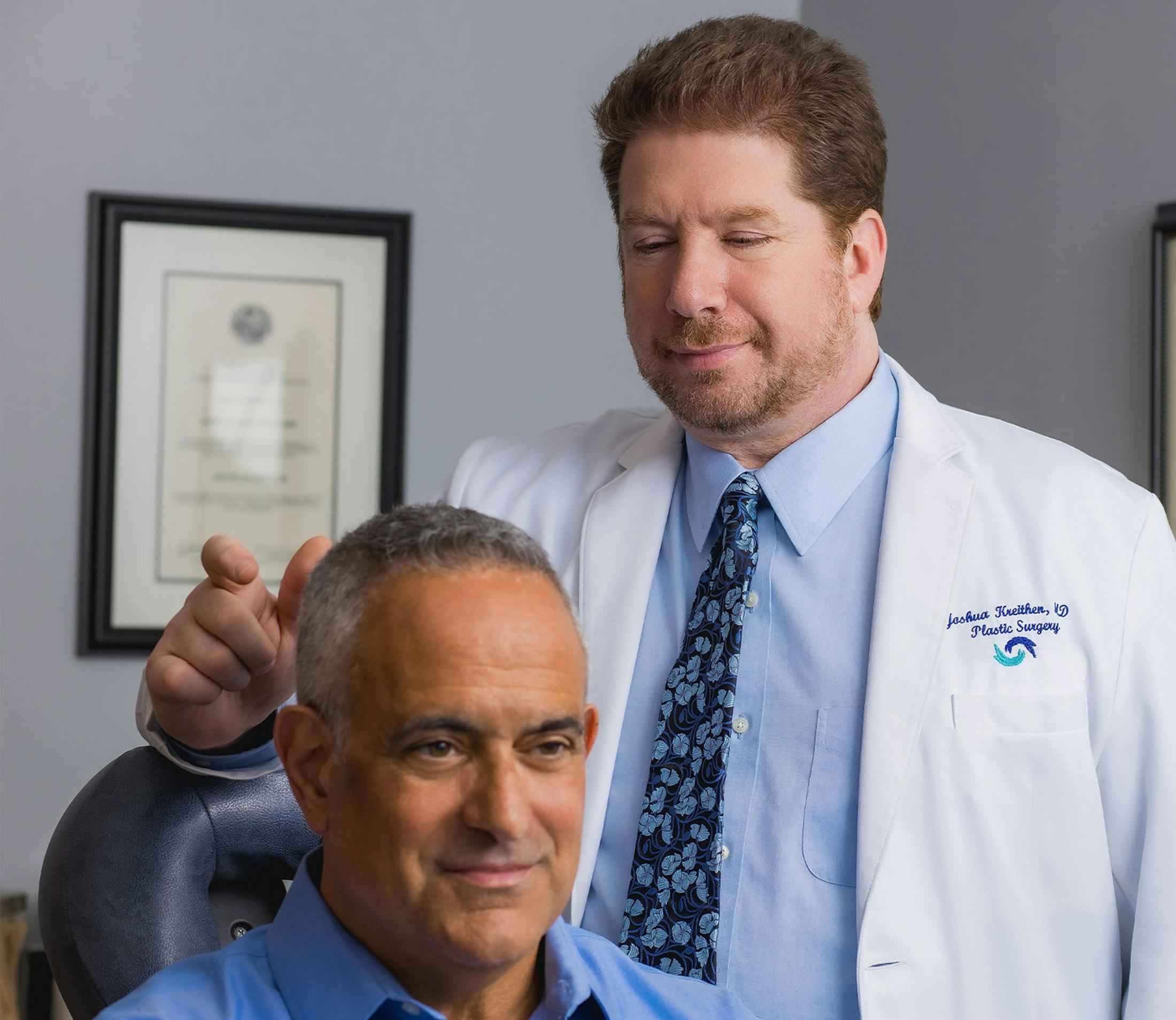 Dr. Kreithen talking to patient in seated in medical chair