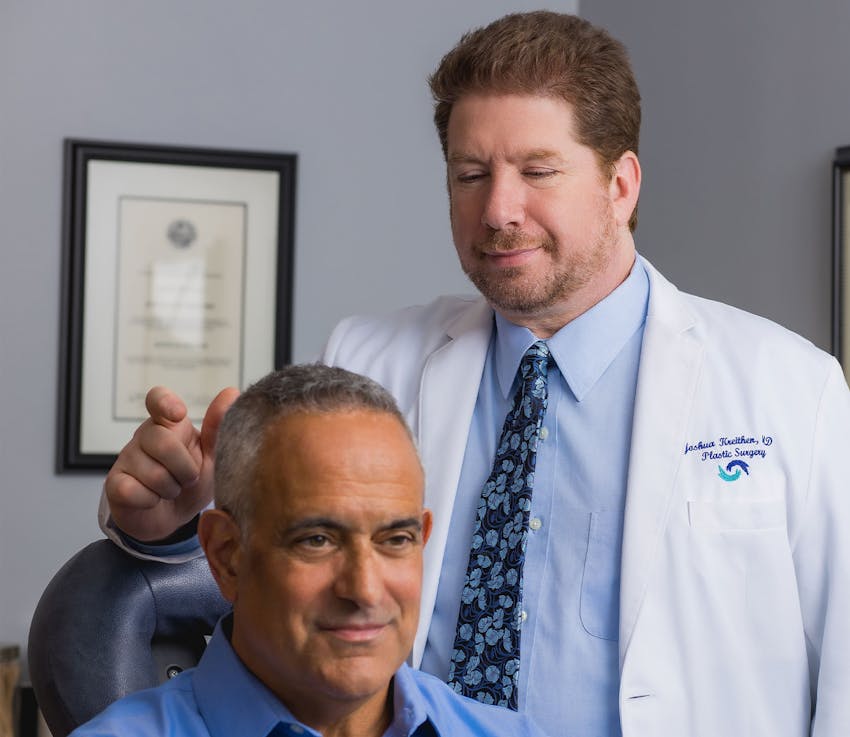Dr. Kreithen talking to patient in seated in medical chair