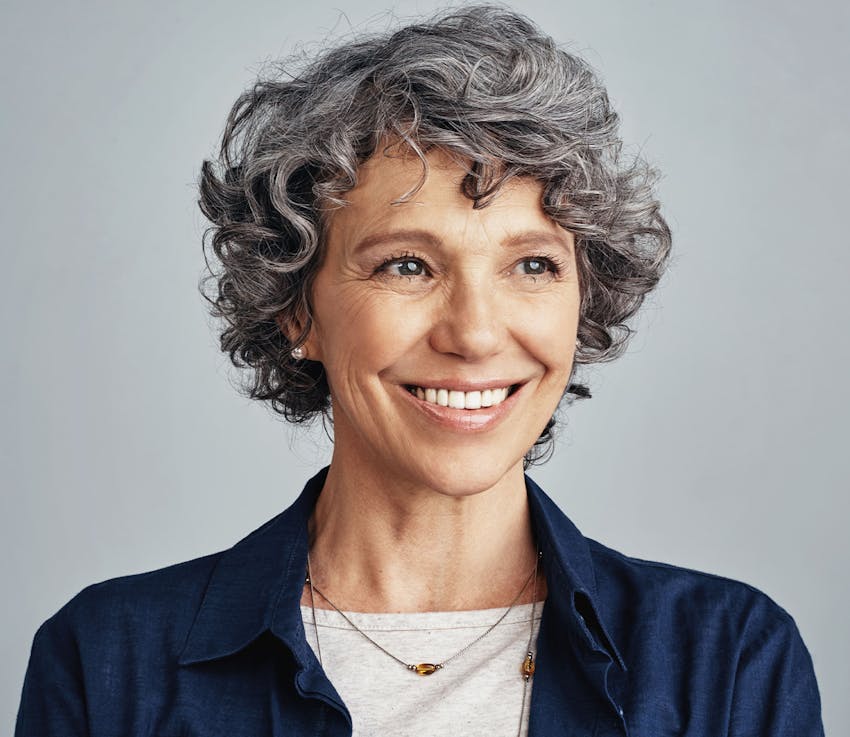 older woman with gray, short hair smiling