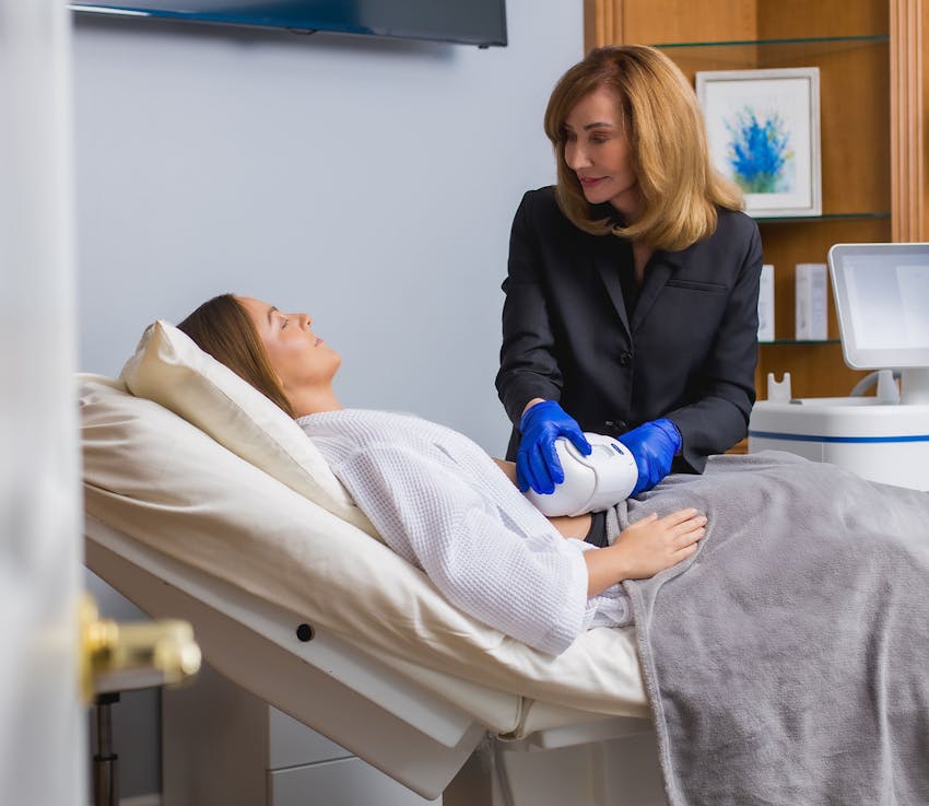 medical personnel using CoolSculpt on patients lower abdomen