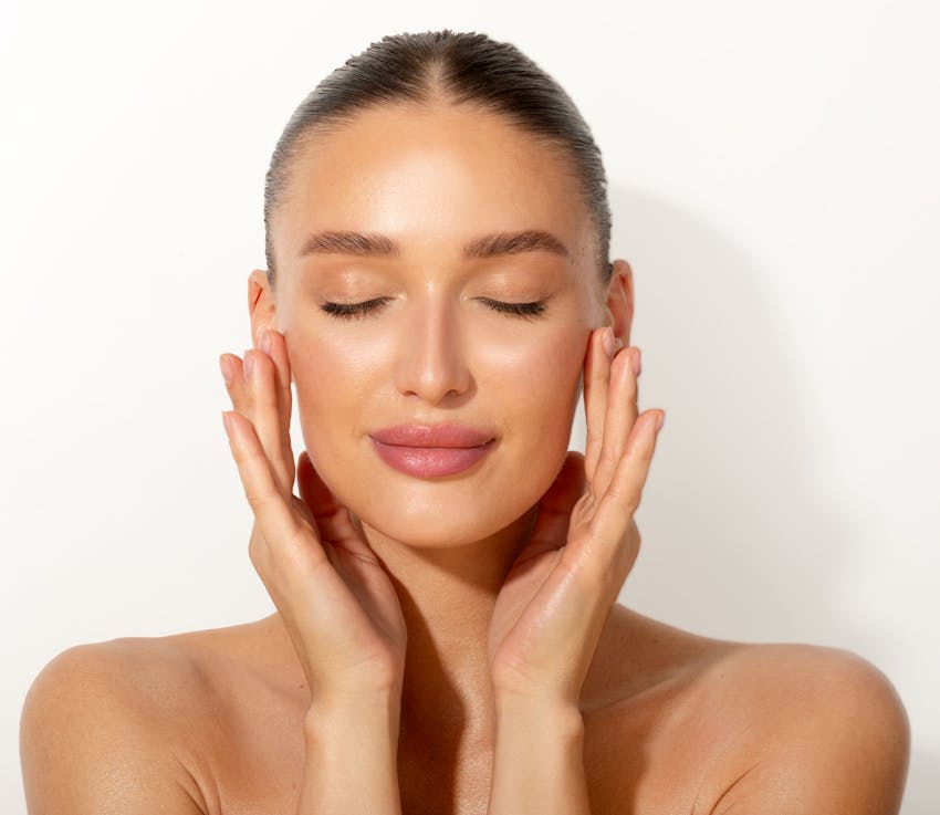 woman touching her temples with her hands and eyes closed