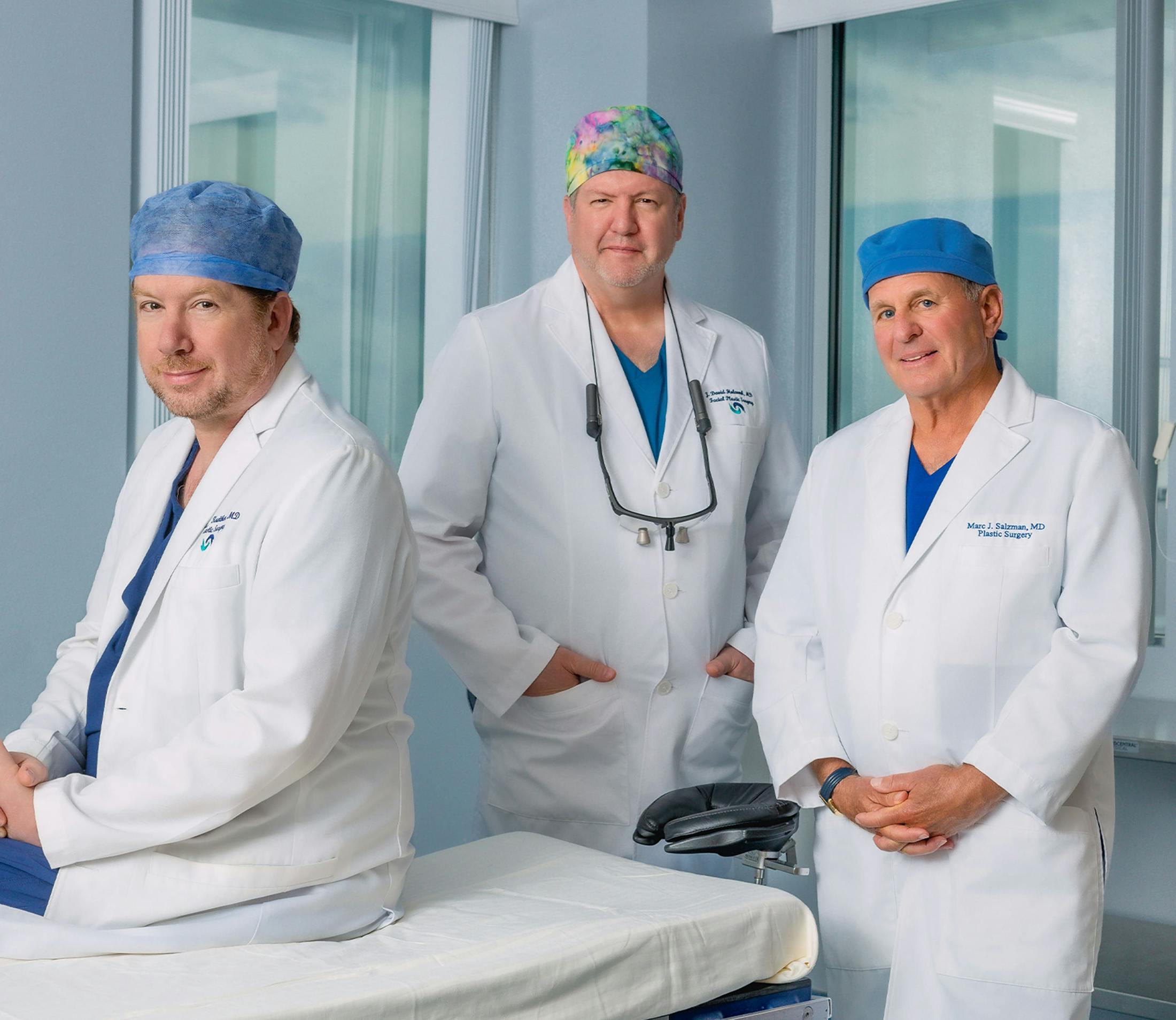 Dr. Kreithen, Dr. Holcomb, and Dr. Salzman dressed in scrubs and medical jackets