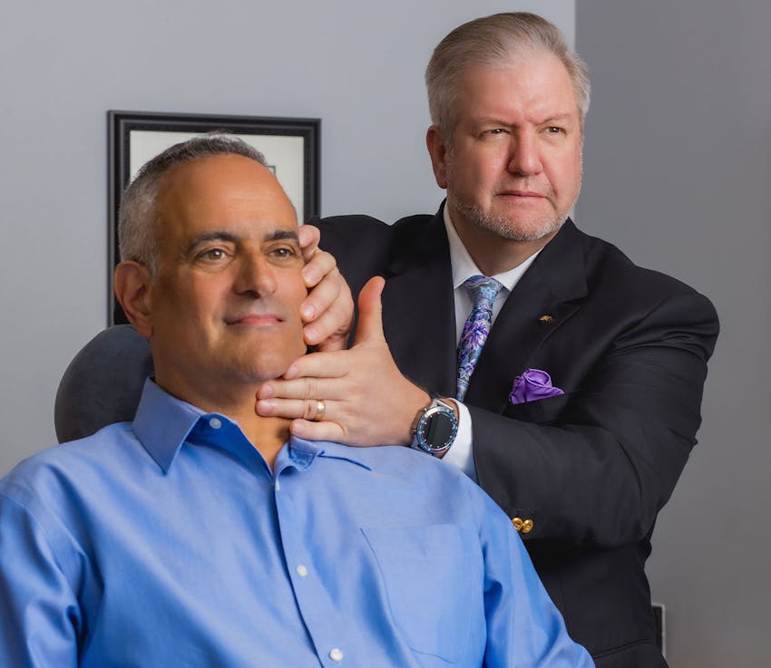 male patient with doctor getting his chin viewed