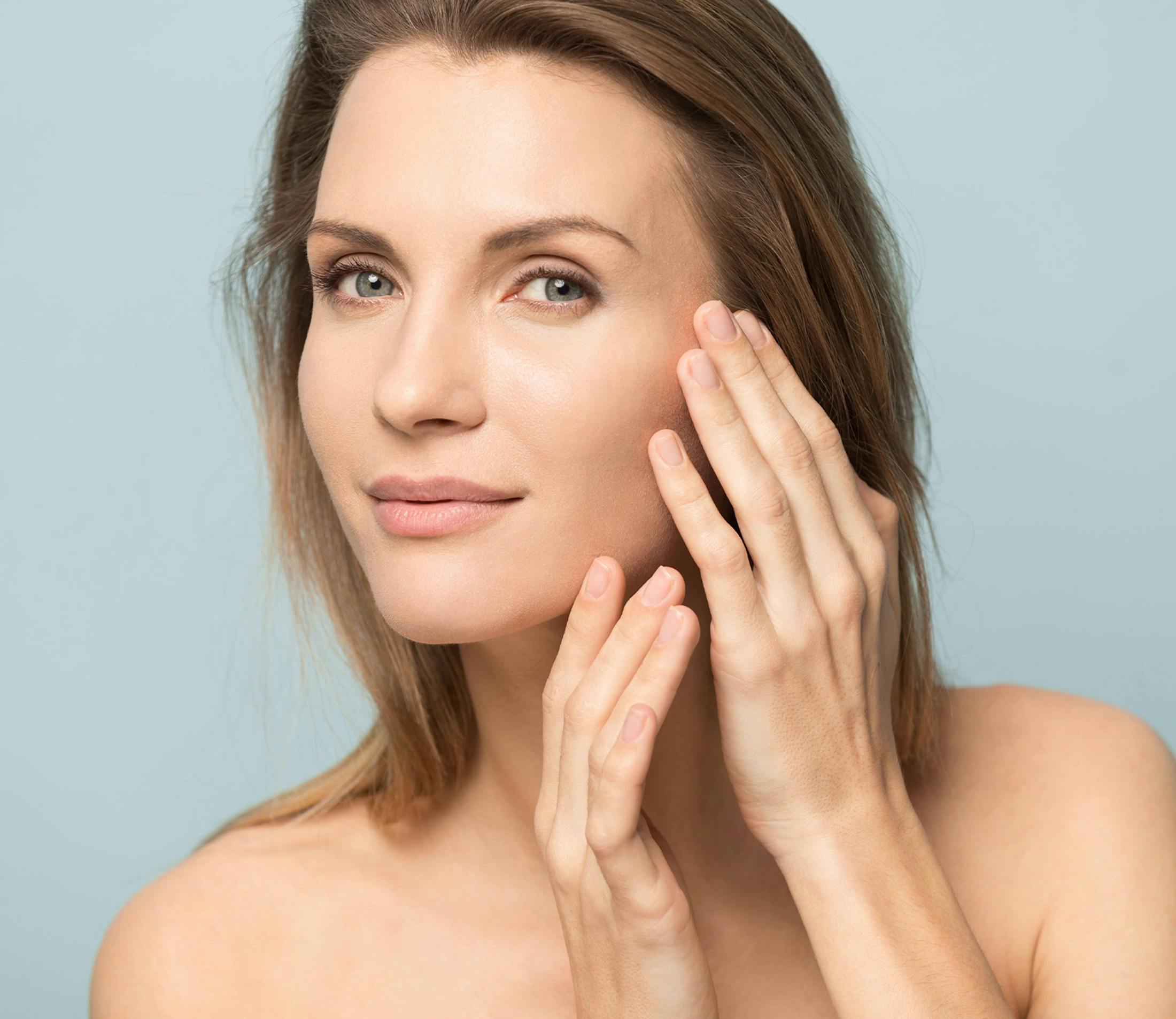 woman touching her chin and temple on one side looking forward