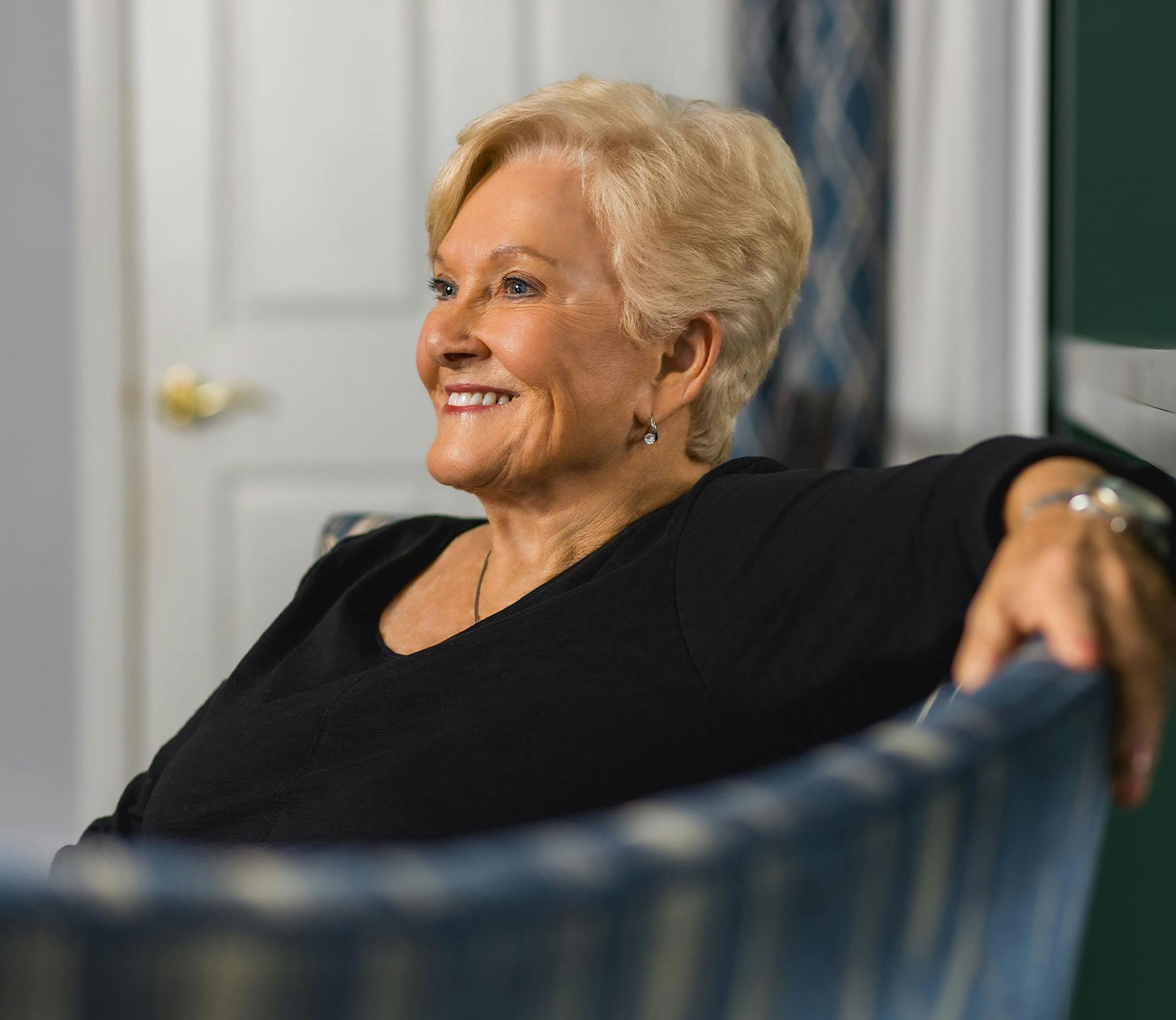 female patient sitting down and smiling