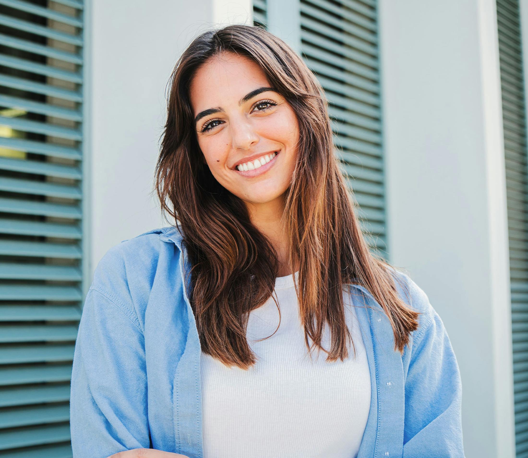 woman in white shirt with blue button-up cover