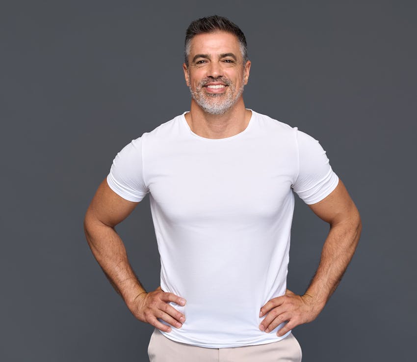 man smiling with his hands on his hips