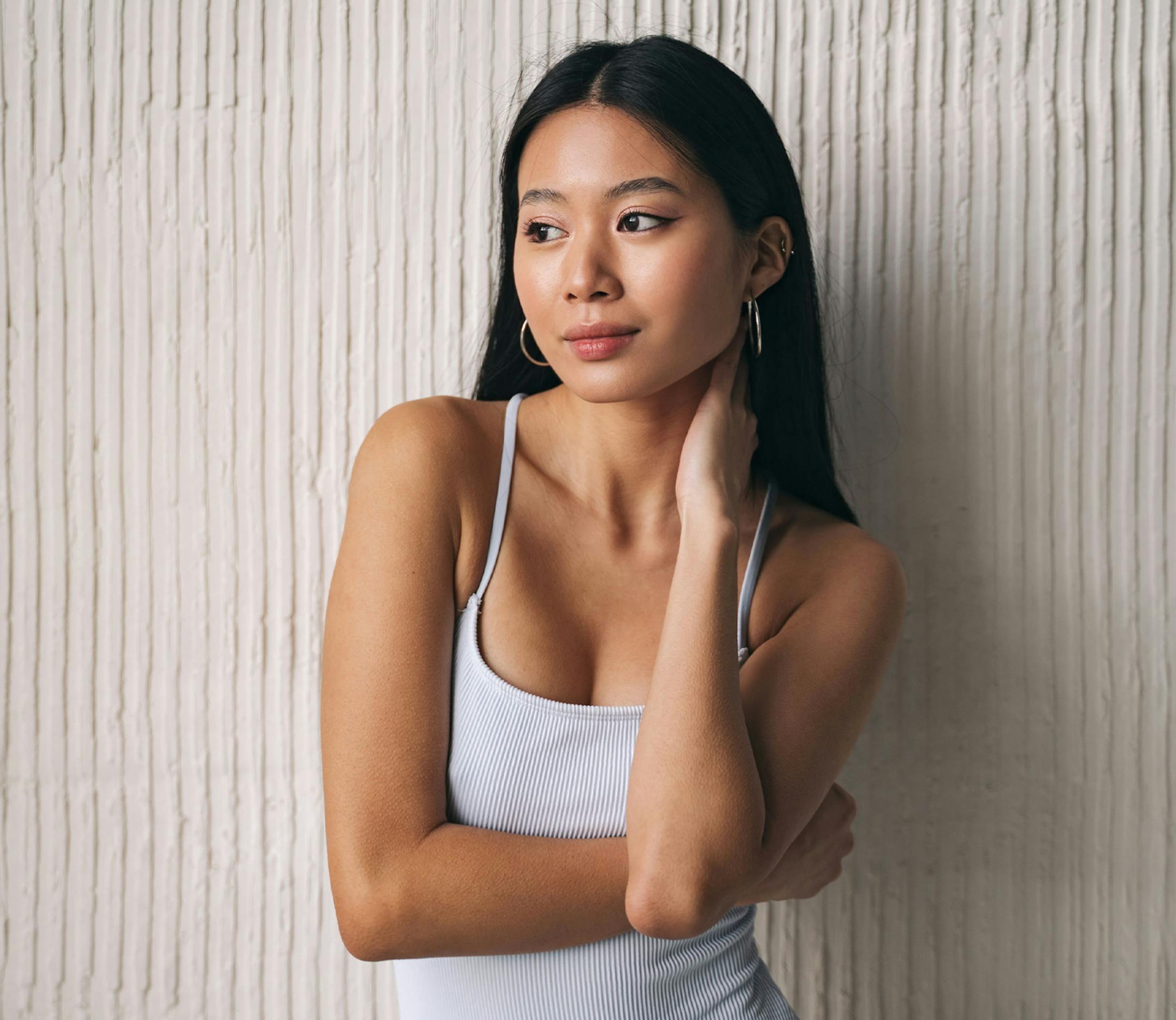 woman with her hand on her neck