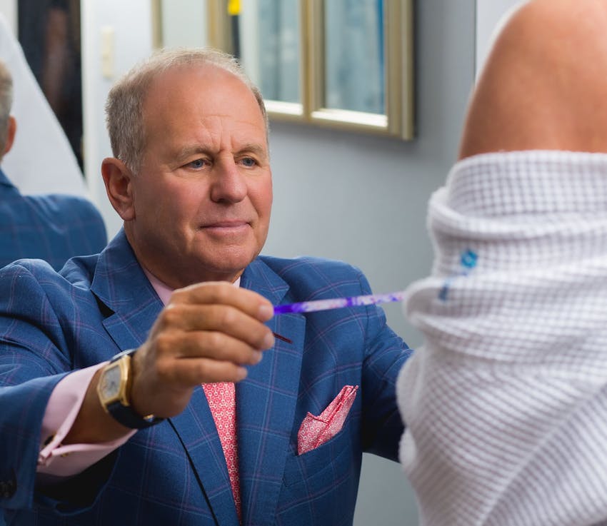 Dr. Salzman measuring a patient's breast