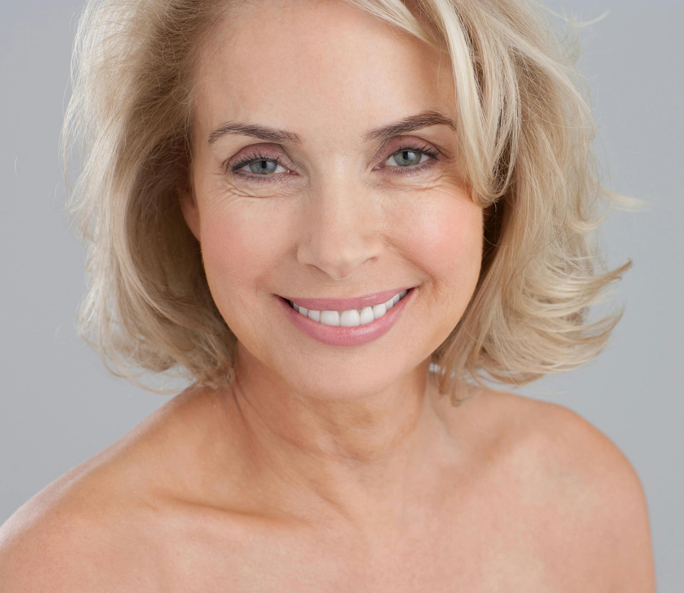 woman with short blonde hair looking forward