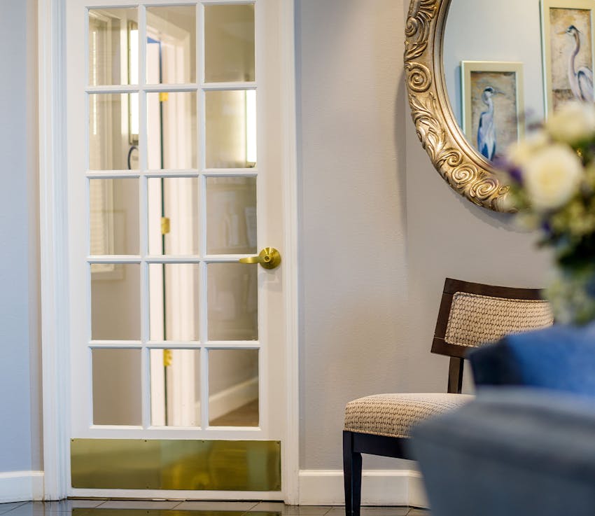 door and chair in Holcomb & Kreithen facilities lobby