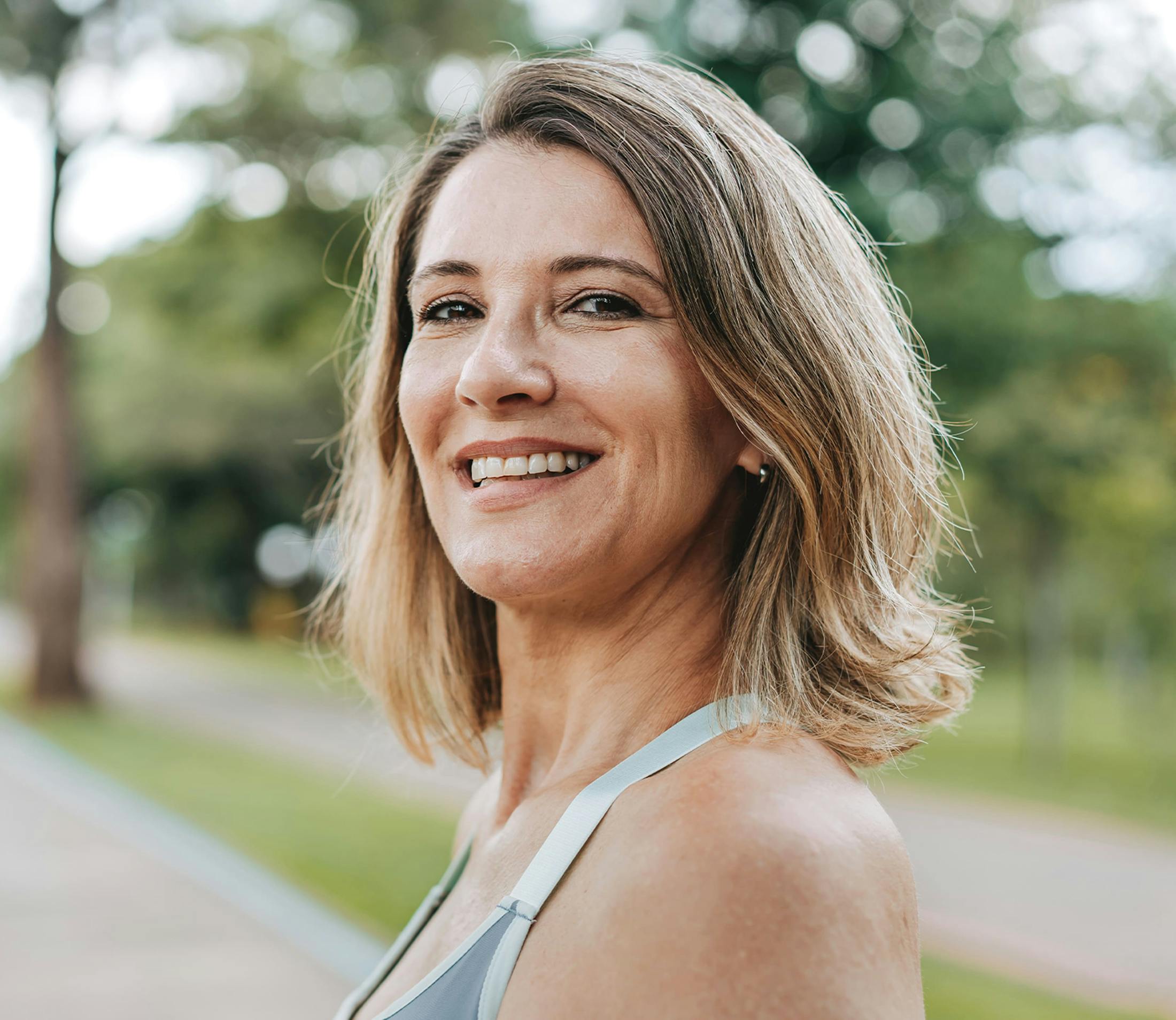 woman with short hair outside smiling
