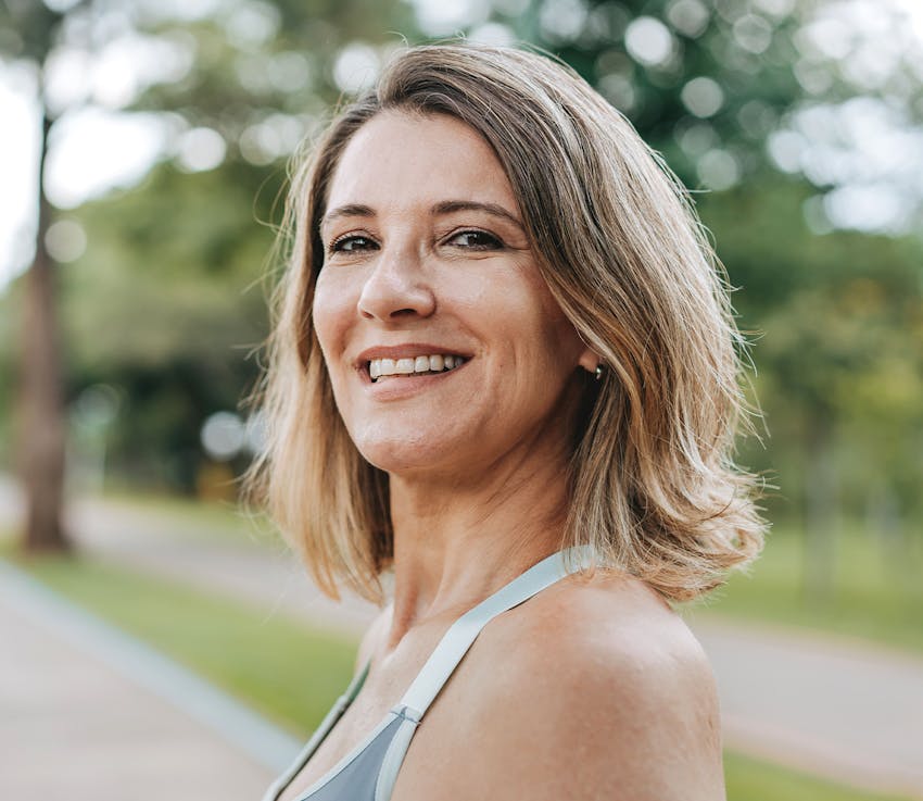 woman with short hair outside smiling