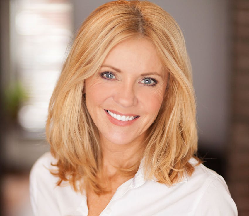 woman in white shirt with hair in blonde straight bob