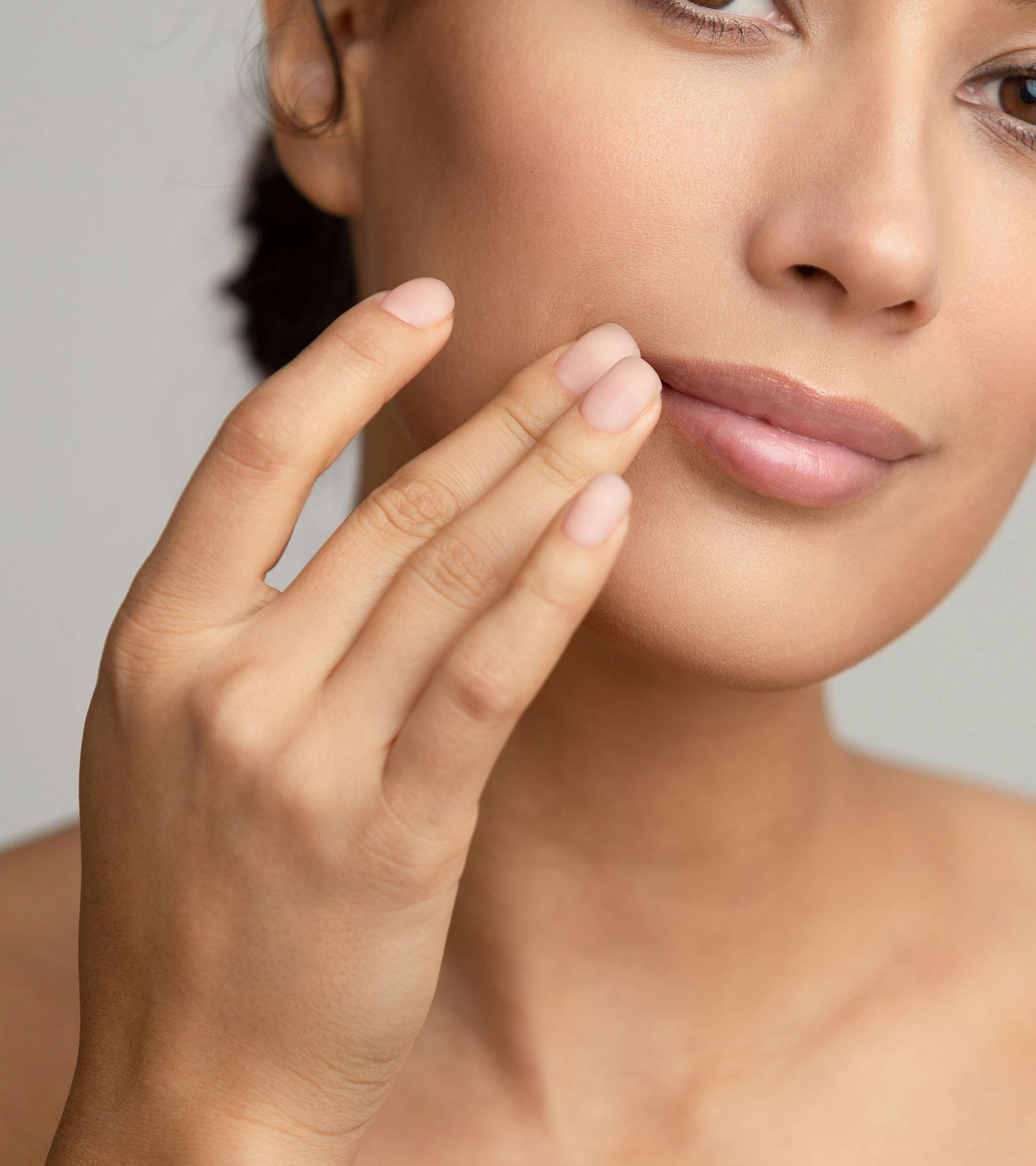 woman touching the corner of her lip