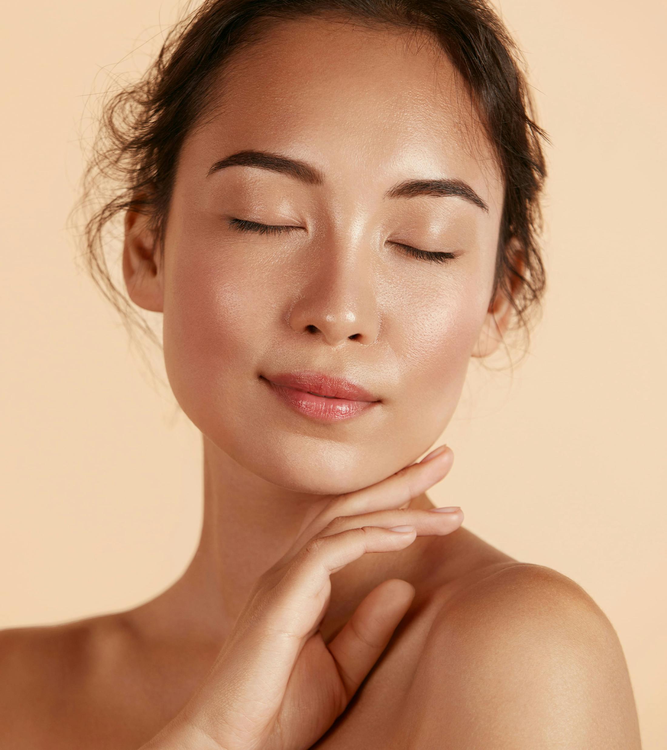 woman touching her chin with the back of her hand and her eyes closed
