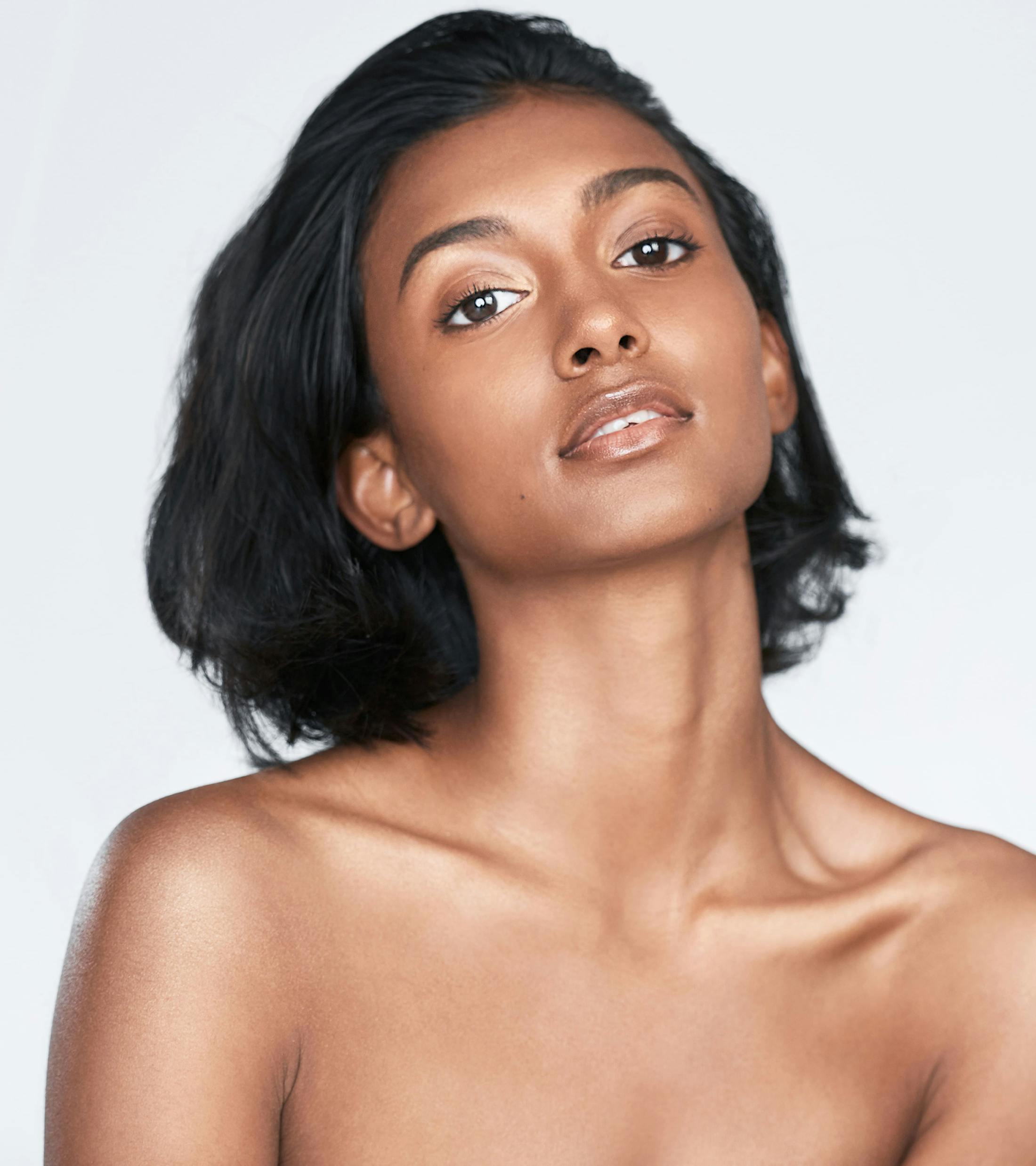 dark haired woman looking forward with her head tilted up