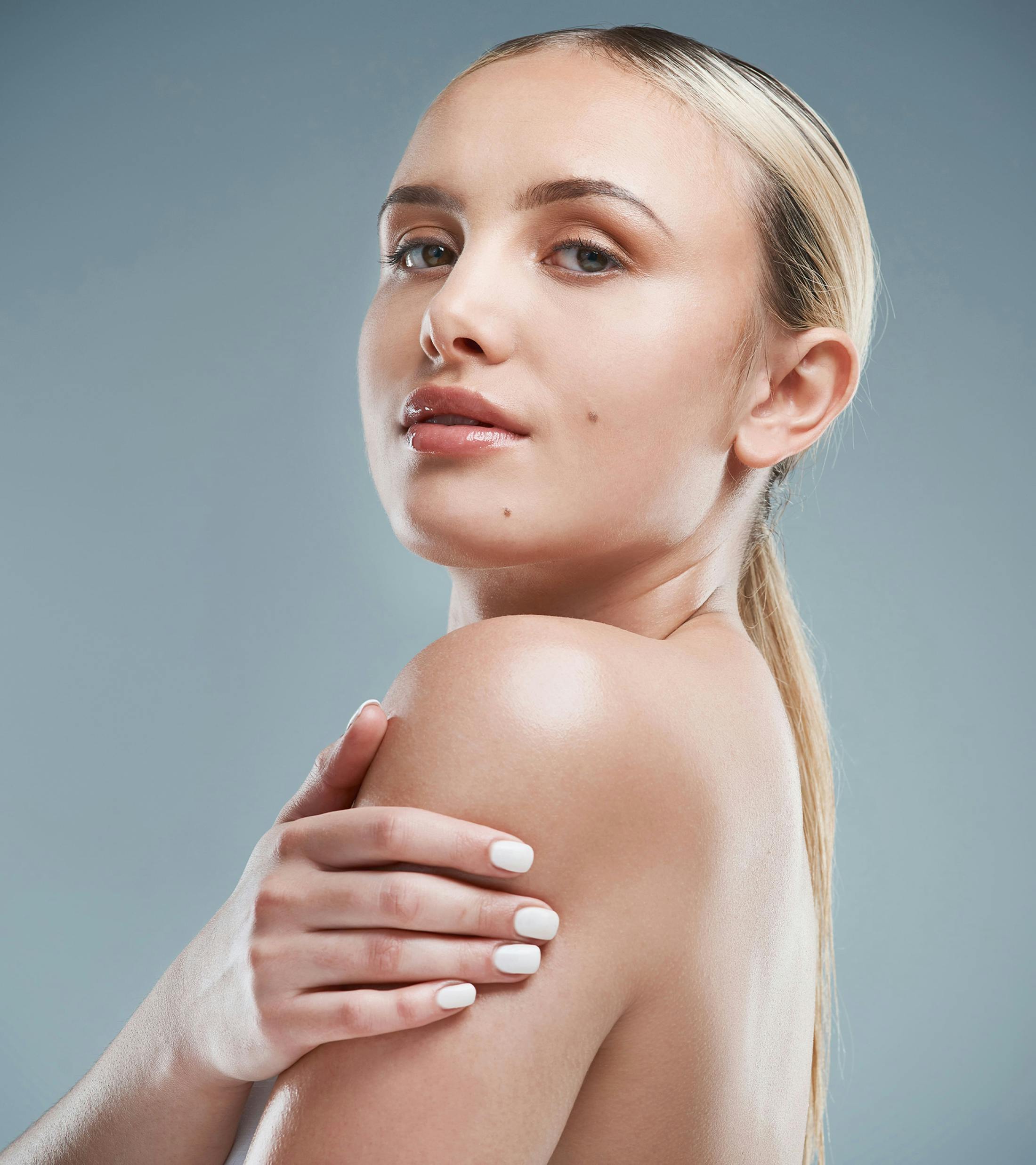 woman with a low pony tail looking over her shoulder