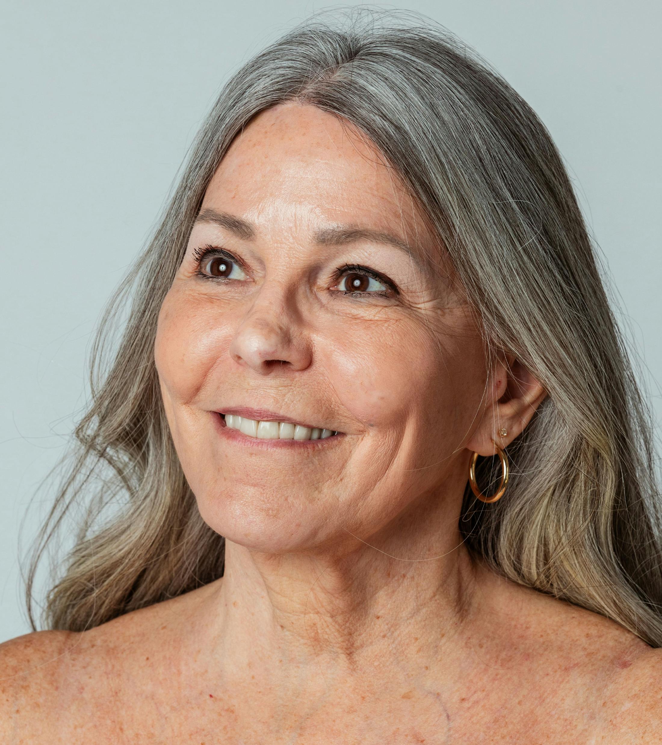woman looking up with her hair behind her shoulders