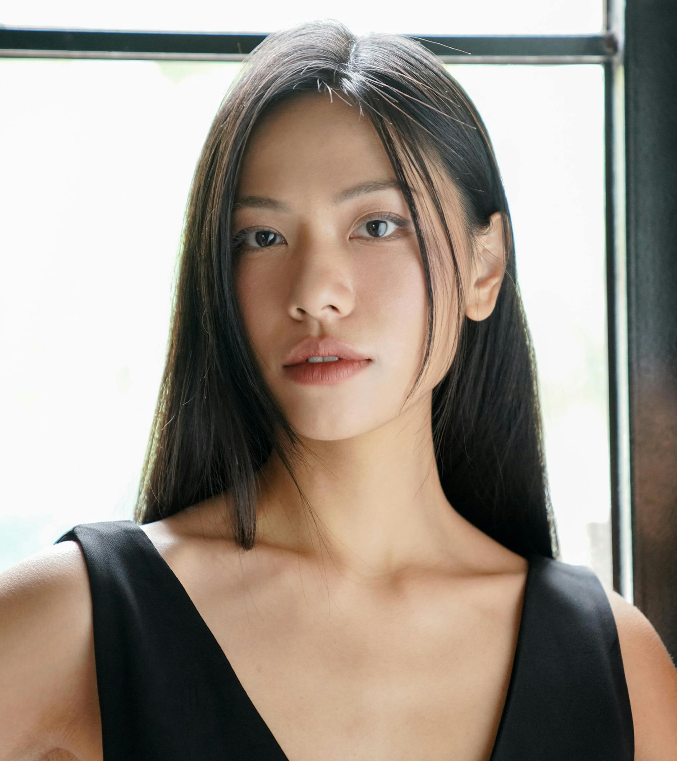 woman with long dark hair wearing v-neck tank top