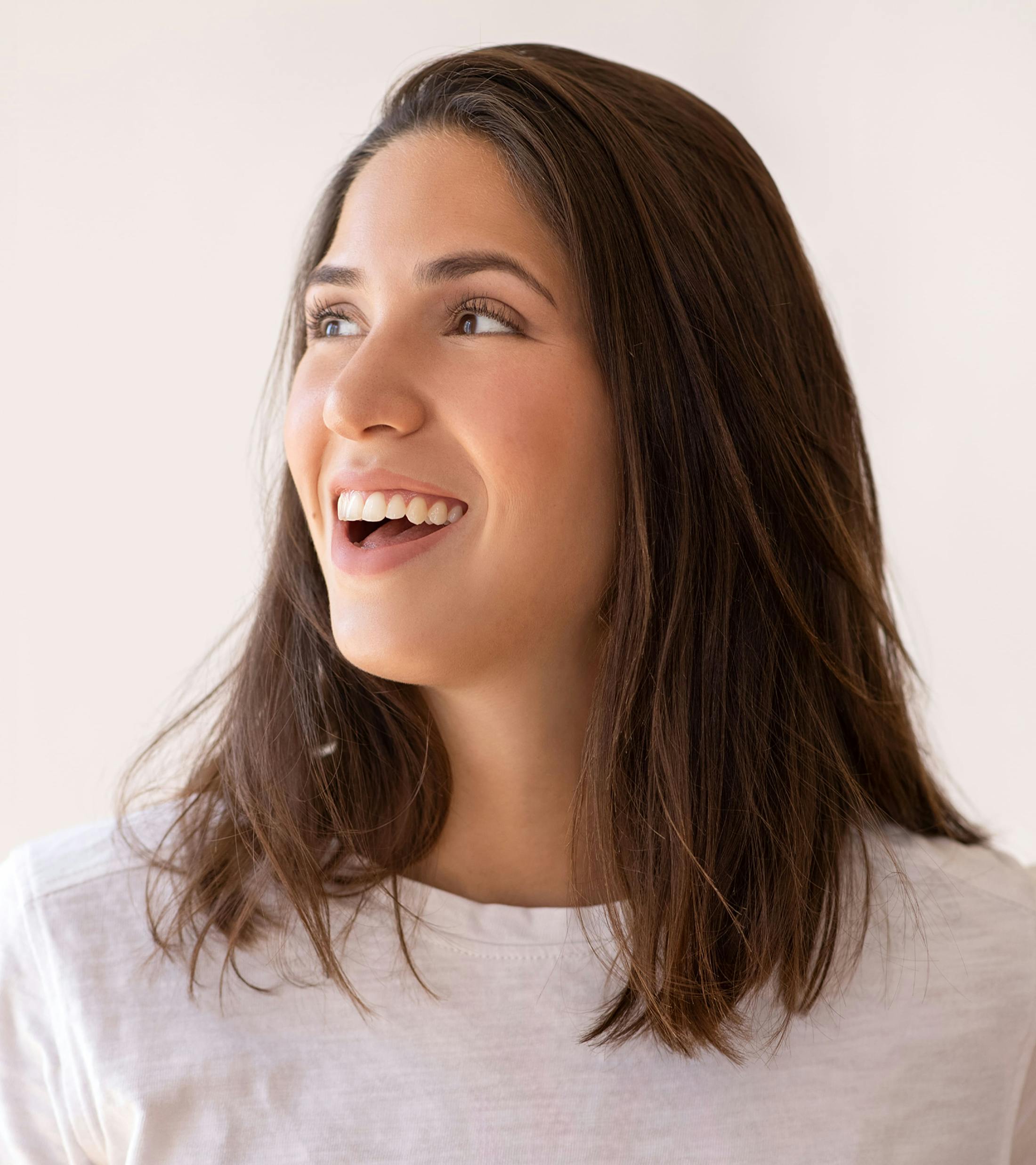 woman with dark brown hair looks to the side