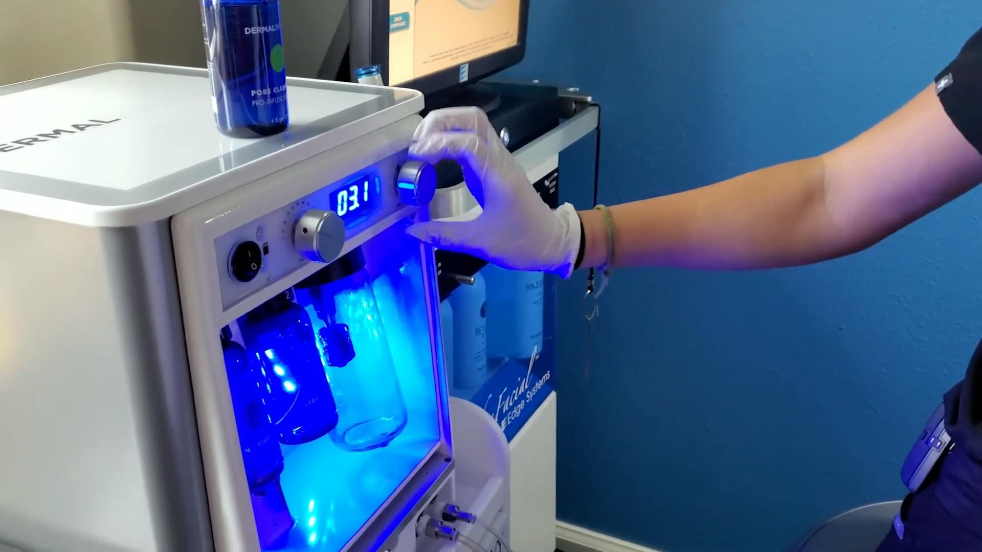 Licensed aesthetician setting up the serum solution for a dermal facial treatment