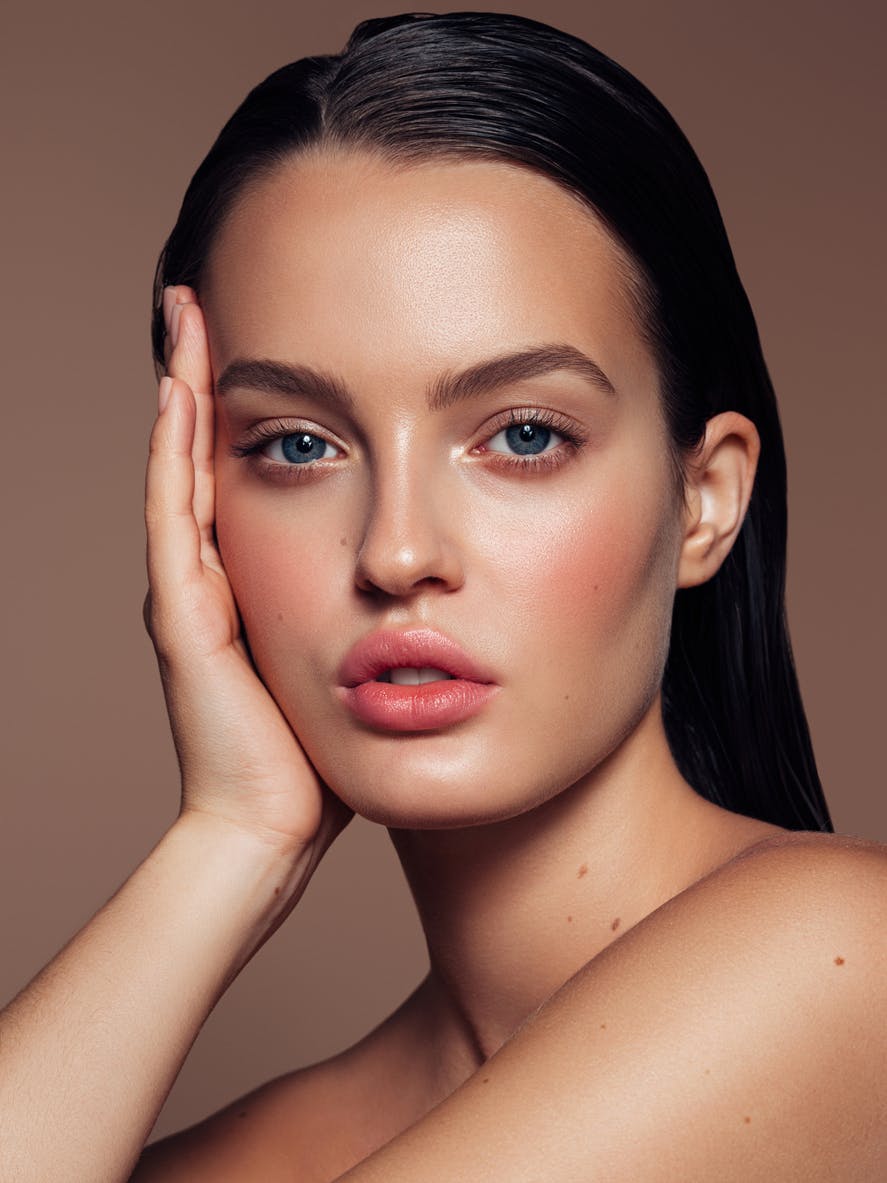 Portrait of a beautiful woman with natural make-up and even skin tone and texture after undergoing a procedure like Halo tribrid laser