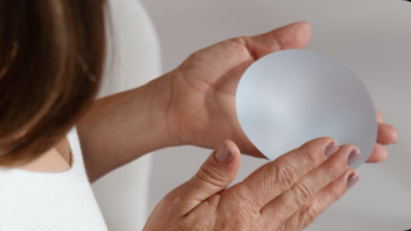 woman holding an implant